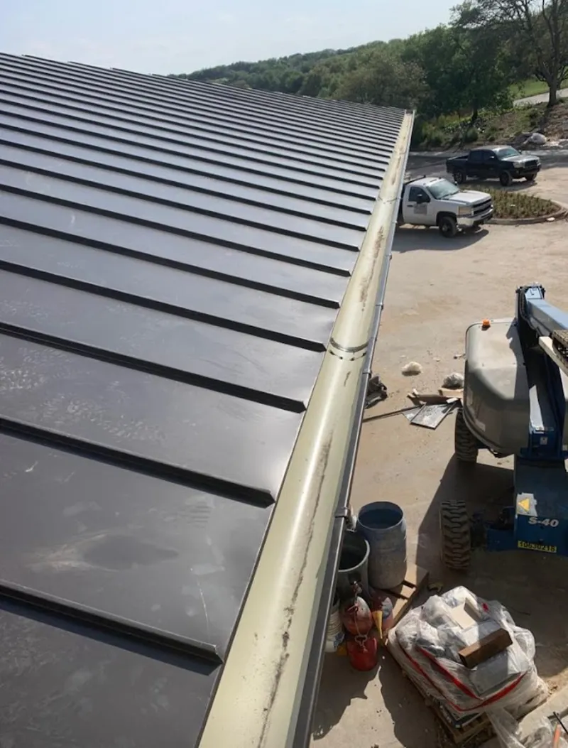 Standing seam panel and gutter detail on a metal roofing jobsite in Spring Garden